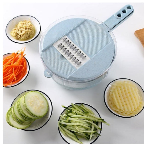 Round mandoline vegetable slicer with grating plate, shown with prepared vegetables and carrots.