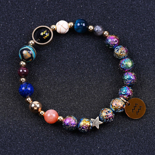 Beaded bracelet with blue, purple and pink stones, star charm, zodiac disc and lobster clasp.