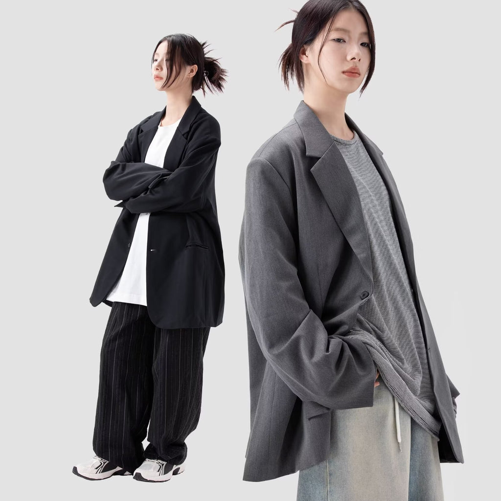 Black loose-fitting coat with notch lapels, button front, long sleeves, flap pockets
