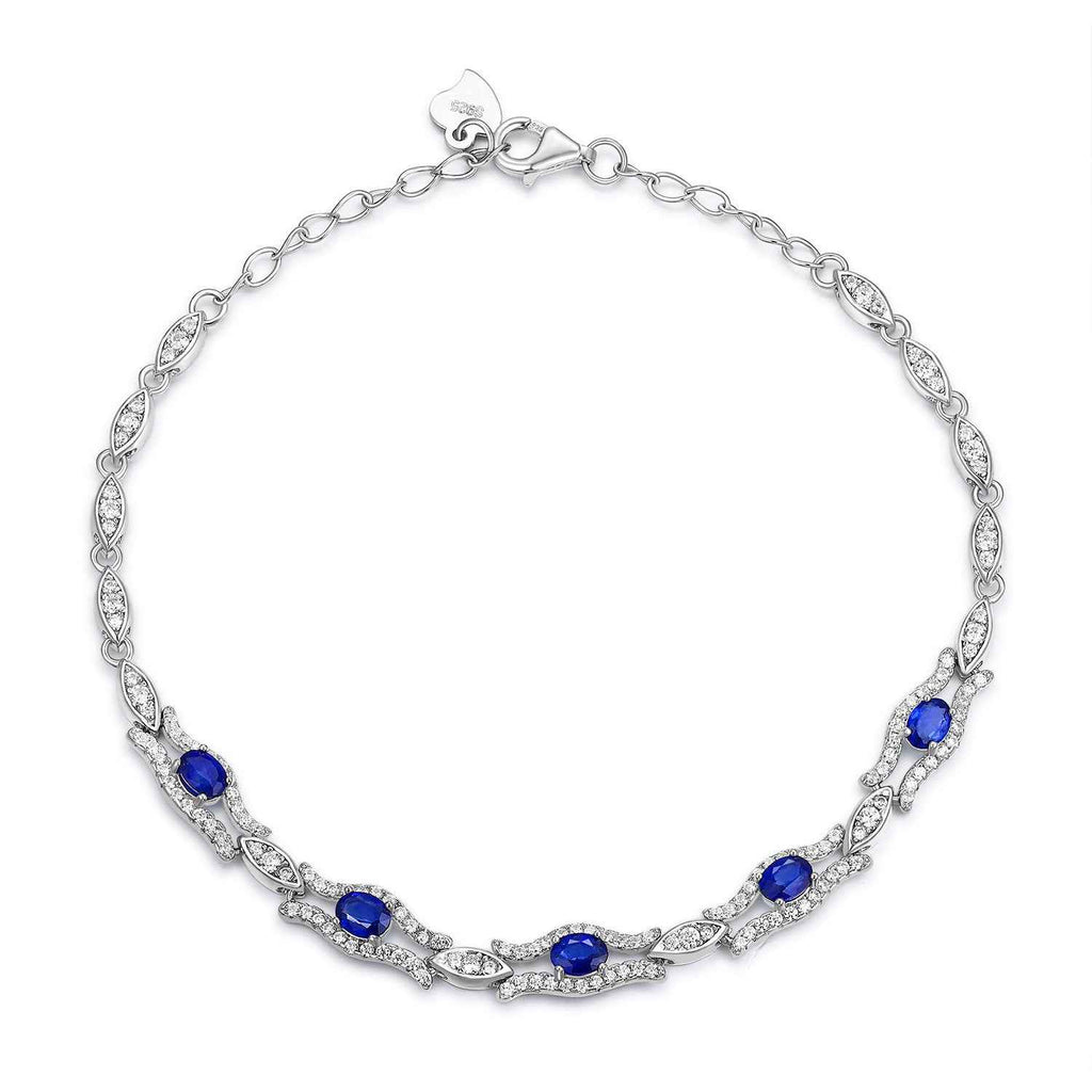 Silver tone sapphire bracelet with blue oval gemstones along the curved chain links