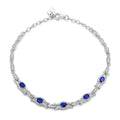 Silver tone sapphire bracelet with blue oval gemstones along the curved chain links