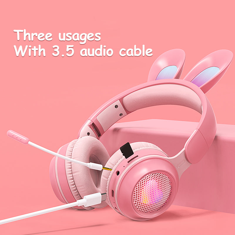 Pink rabbit-ear wireless headphones with padded over-ear cups and 3.5mm audio cable