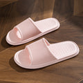 Pink slide slippers with striped strap and textured diamond footbed