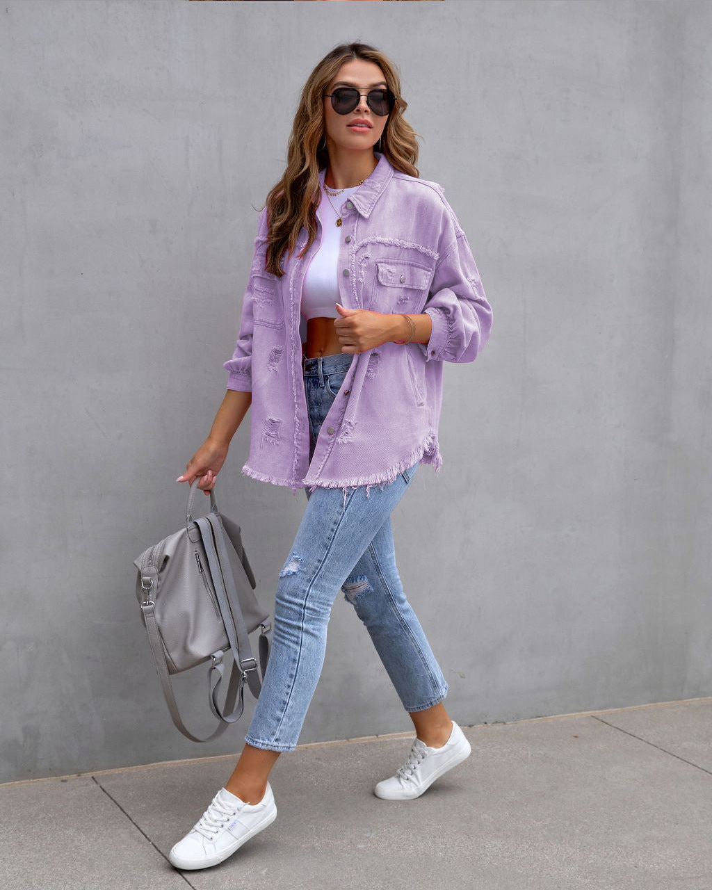 Women’s ripped denim shirt jacket in light purple, with button front and patch pockets
