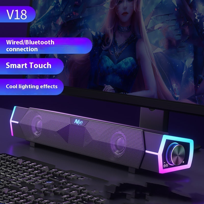 Black soundbar speaker with dual grille, purple RGB frame, front volume knob