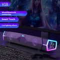Black soundbar speaker with dual grille, purple RGB frame, front volume knob