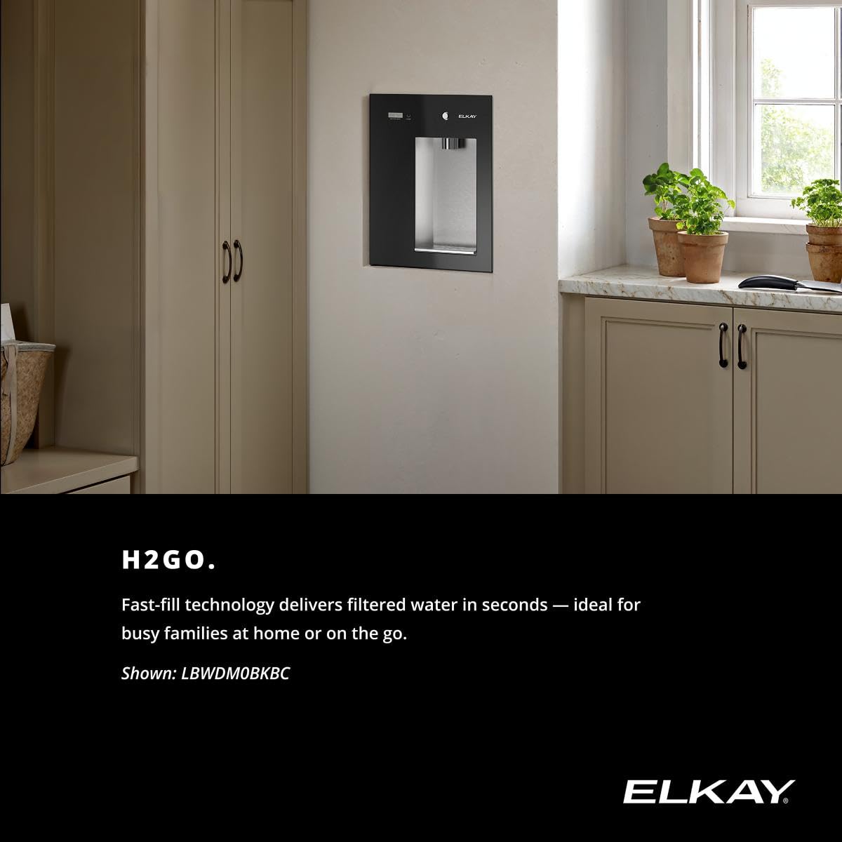 Wall-mounted water dispenser on an interior wall near cabinetry, with black front panel