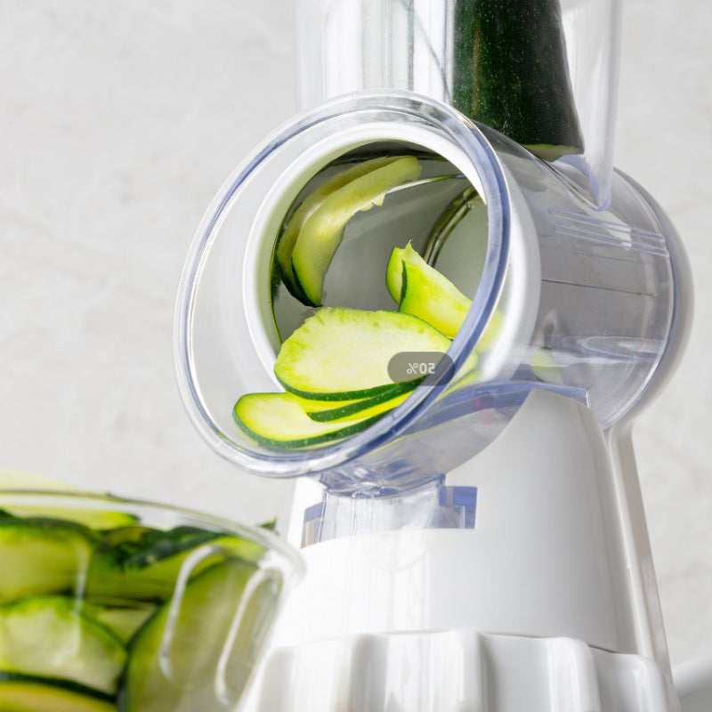 White manual vegetable slicer chute holding zucchini slices