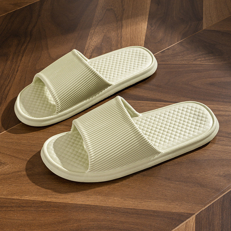 Light green slide slippers with striped strap and quilted diamond footbed