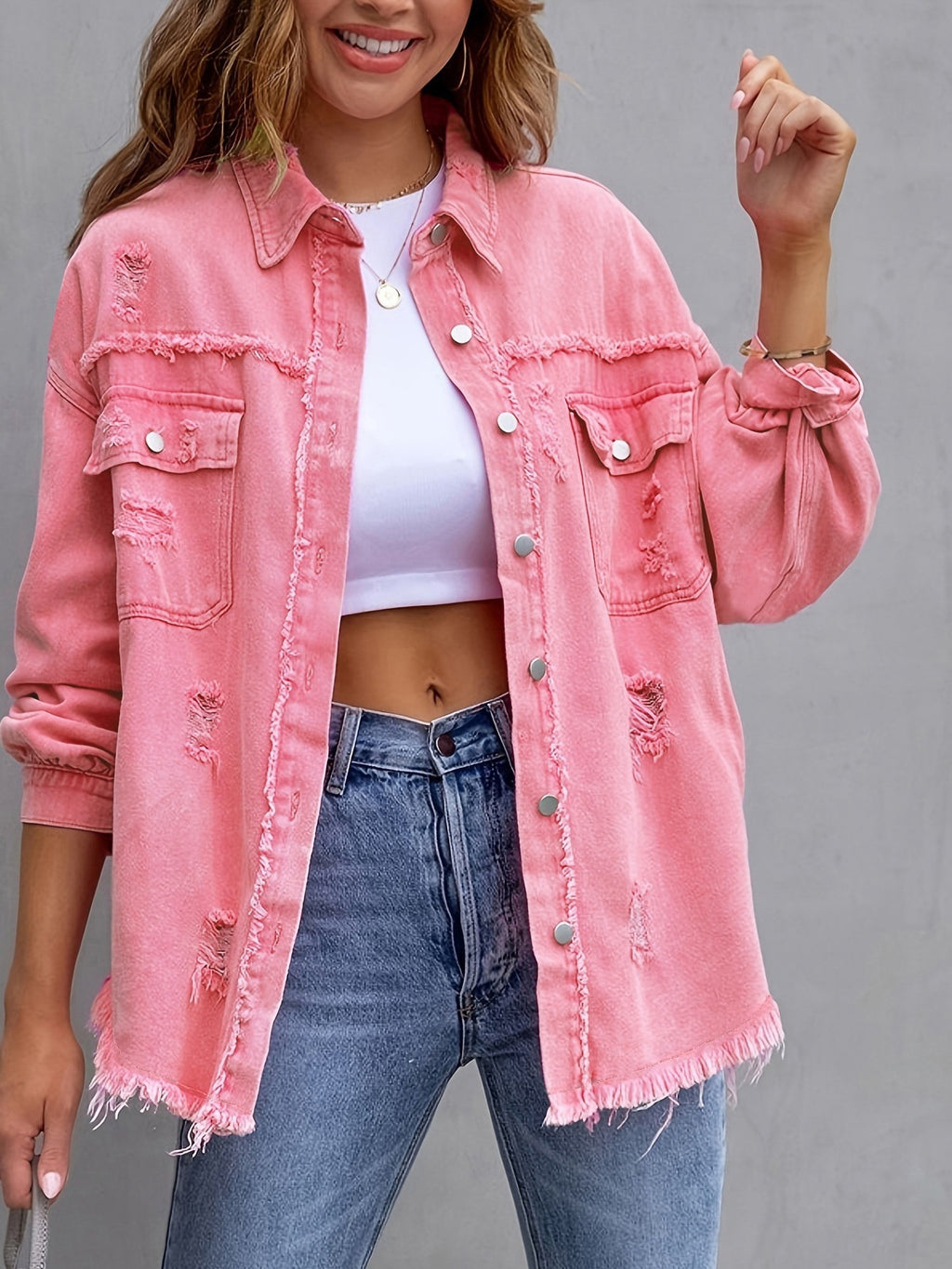 Pink ripped denim shirt jacket with button front and chest pockets