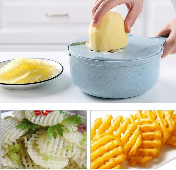 Kitchen mandoline slicer bowl with lid, holding a peeled yellow potato for slicing.