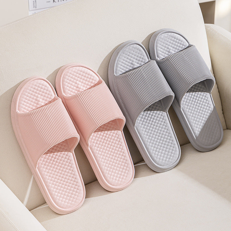 Pink and gray slip-on slippers in a display box, textured diamond footbeds