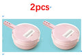 Two pink mandoline slicers with grating inserts, shown side by side for quantity.