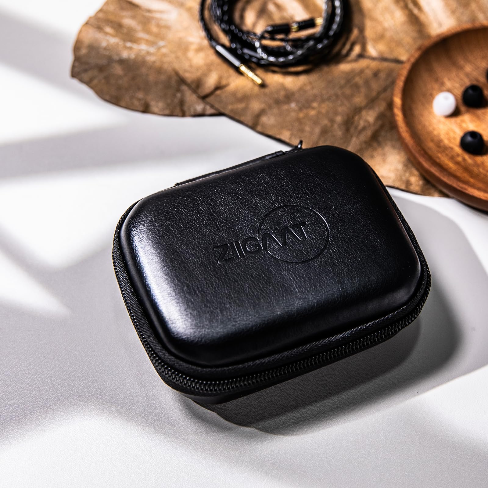 Black leather IEM earbud storage case with zipper and embossed ZiiGaat logo