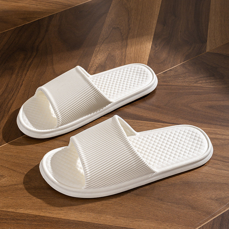 White slide slippers with striped upper and textured diamond footbed