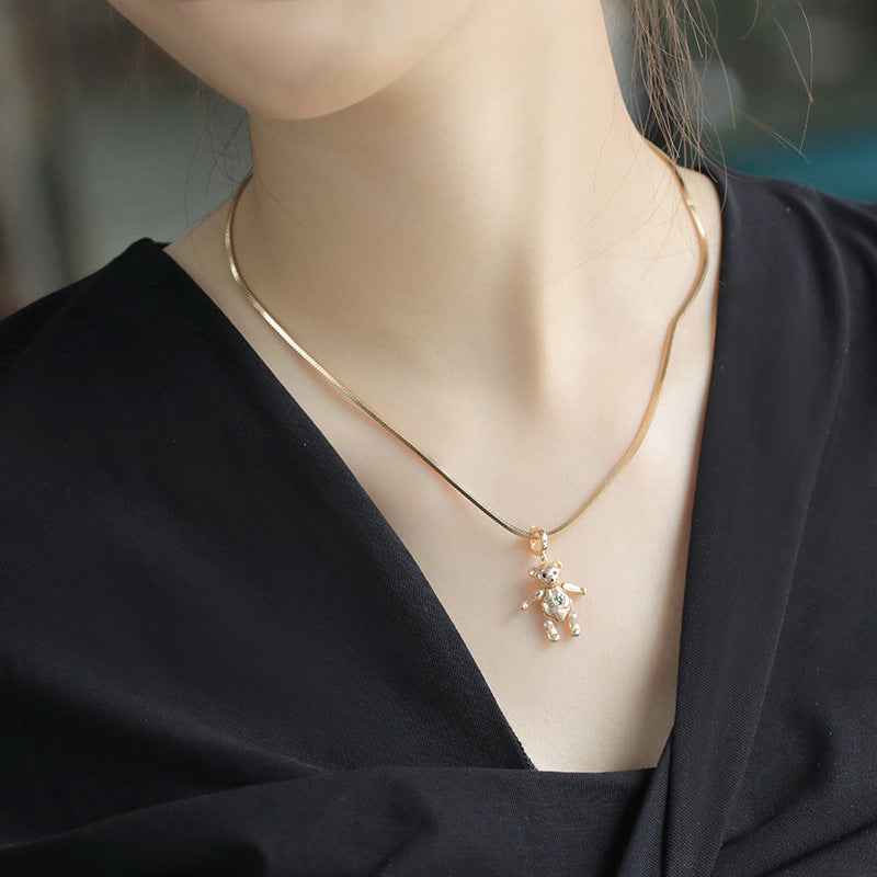 Gold bear pendant necklace with small dangling bear charm on thin chain