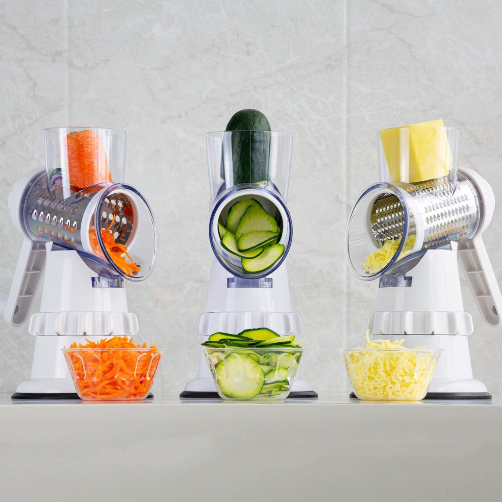 White 3-in-1 vegetable slicer with grater drums and sliced vegetables
