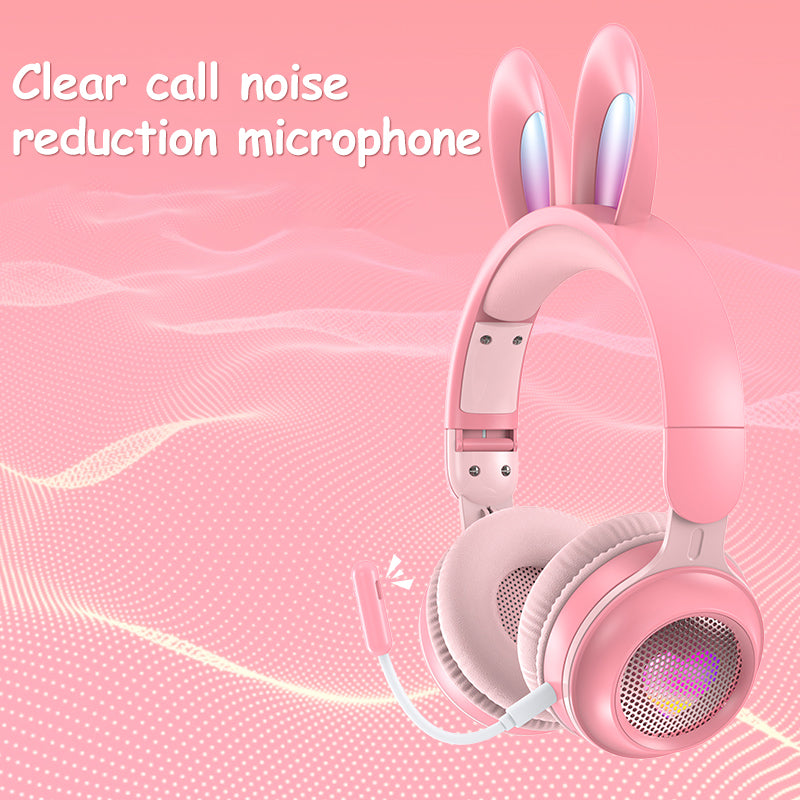 Pink rabbit-ear wireless headphones with padded over-ear cups and glowing speaker grill