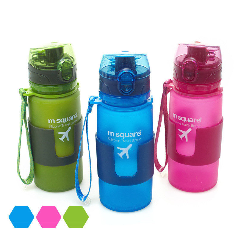 Silicone travel water bottles in green, blue, and pink with carry straps and flip tops