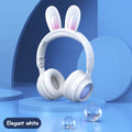 White rabbit-ear wireless headphones with padded over-ear cups and glowing speaker grill