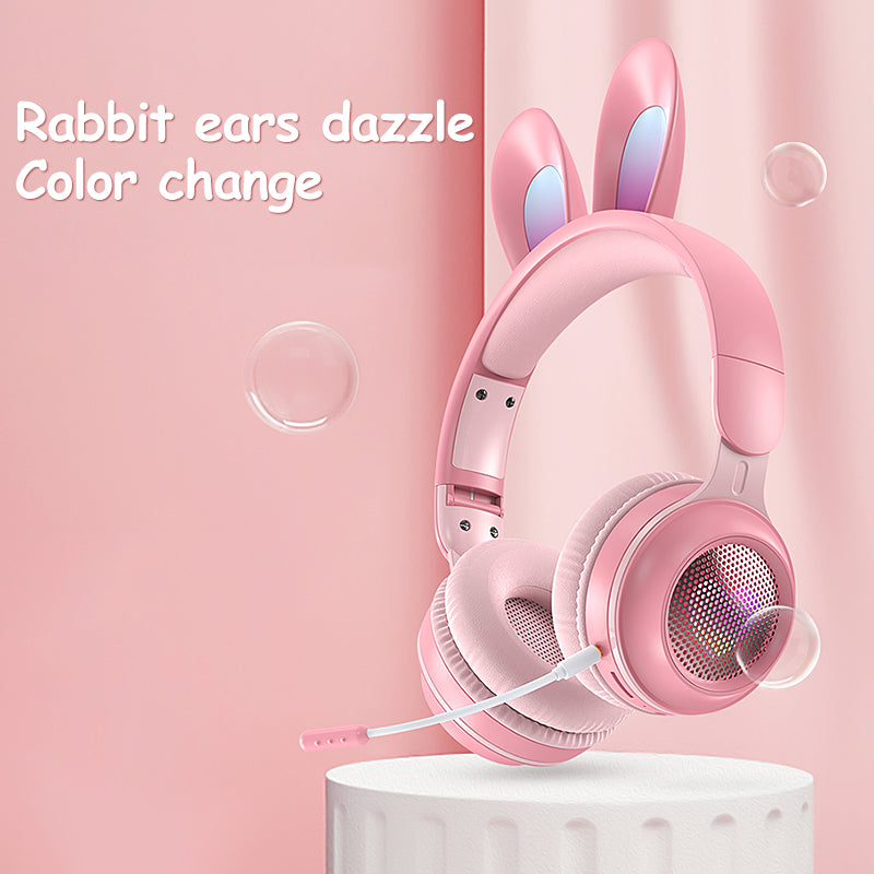 Pink rabbit-ear wireless headphones with over-ear cushions and glowing speaker grill
