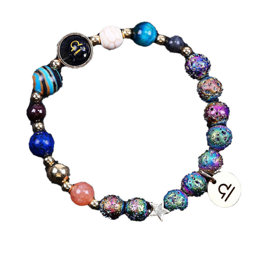 Beaded bracelet with multicolor speckled beads, star charm, zodiac disc, blue and white beads.