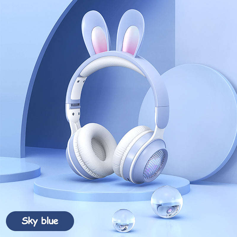 Sky blue rabbit-ear wireless headphones with padded over-ear cups and glowing speaker grill